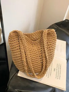 Bohemian hand-woven straw tote bag for summer beach trips in a warm khaki camel tone