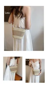Detail view of a striped woven beach bag with adjustable leather strap in summer style