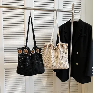 Close-up of bohemian knit tote bag featuring crochet sunflower and diamond hollow patterns