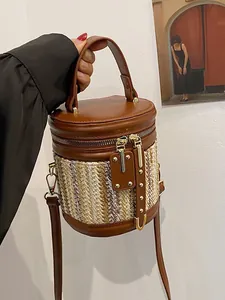 Rainbow woven bucket bag with brown leather accents and a stylish crossbody strap