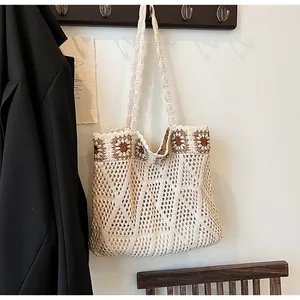Macro detail of hand-woven crochet tote bag showing ivory open knit and daisy pattern