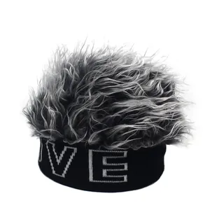 Close-up of black knit beanie with silver wig hair and embroidered VE lettering