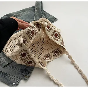 Close-up of bohemian knit tote bag showing intricate sunflower crochet and scallop edges