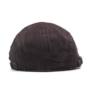Adjustable back detail of a washed cotton newsboy cap with vintage bronze buckles