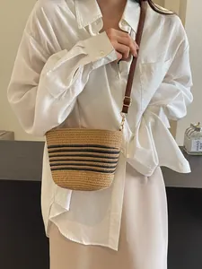 Fashionable woven straw shoulder bag with black stripes and adjustable leather strap