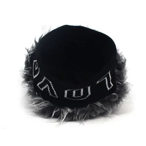 Detailed close-up of knit beanie with faux fur trim and white VAL embroidery detail
