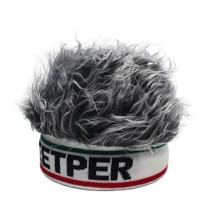 Macro detail of knit beanie featuring grey curly synthetic hair wig and ETPER logo