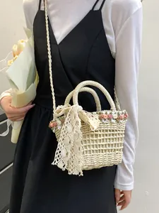 Fresh straw woven bucket bag with lace bow and floral accents for summer vacation beach look