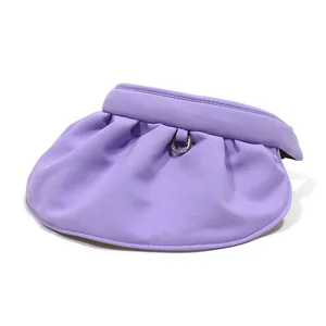 Detail of purple sun visor hat featuring a wide pleated brim and stylish metal buckle