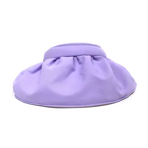 Detail of purple wide brim shell sun hat featuring elegant wave fold soft fabric texture