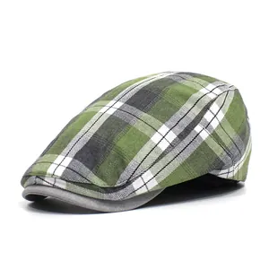 Detailed view of the green plaid pattern texture and gray brim on this stylish flat cap
