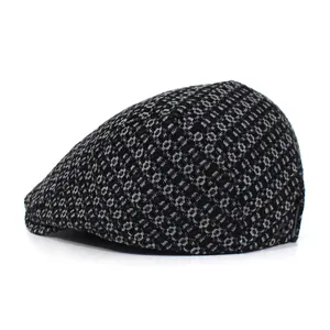 Side view of denim jacquard flat cap featuring black and grey geometric pattern