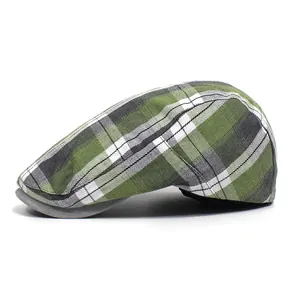 Side view of checkered flat cap with green plaid fabric and solid grey visor detail