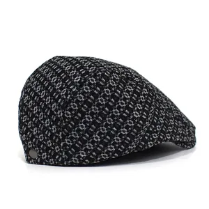 Detailed macro view of woven fabric texture and circular patterns on a black newsboy cap