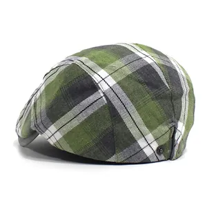 Side view of checkered flat cap showing green, white and grey plaid and metal buckle
