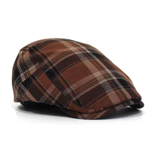Detailed side view of classic British brown plaid beret cap with cotton blend texture