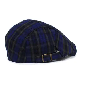 Detail view of the vintage plaid beret featuring a bronze metal adjustable back buckle