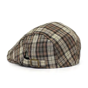 Detail of adjustable bronze buckle and classic checkered fabric on retro beret hat