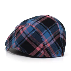 Detailed view of vintage plaid flat cap with navy and pink grid pattern and metal buckle