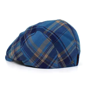 Detail view of British plaid flat cap in blue and brown with metal side buckle