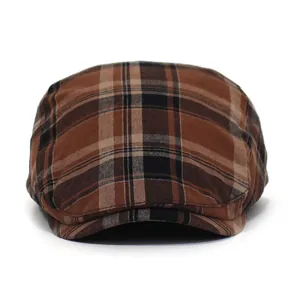 Detailed close-up of brown British plaid pattern on flat cap wool blend texture