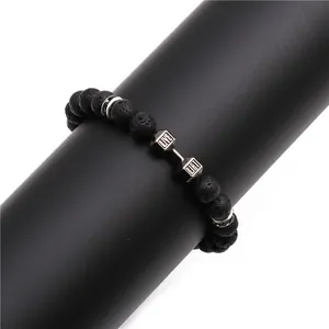 Lava stone bead bracelet featuring silver dumbbell charm with Live and Lift engraving