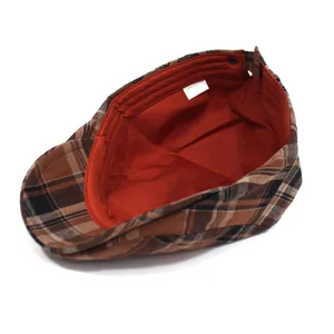 Detail view of British vintage plaid flat cap featuring 100% cotton inner lining tag