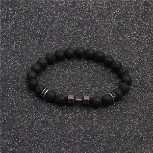 Lava rock beaded bracelet with silver dumbbell charm on dark sparkling background
