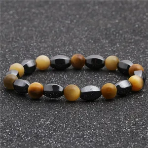 Macro view of beaded bracelet with tiger eye stones and faceted hematite beads