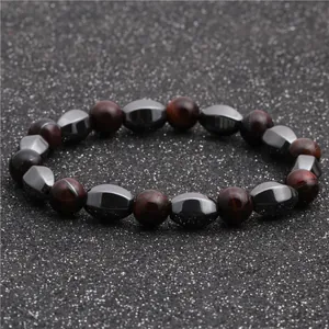 Detailed view of red tiger eye beads and grey hematite stones on an elastic bracelet