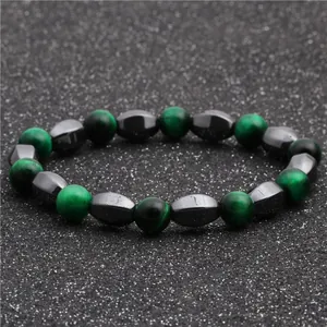 Macro shot of opal and hematite beaded bracelet with polished green and grey stones