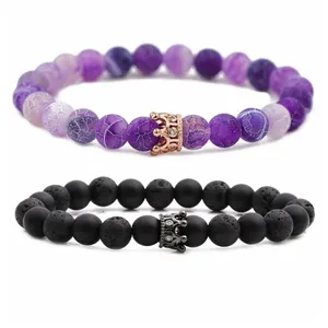 Crown beaded bracelet set with purple agate and black lava stones on white background