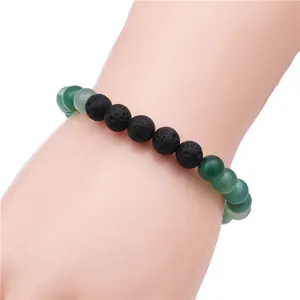 Detail of green agate beads and black lava rock beads on a crown beaded bracelet