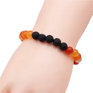 Close-up of lava stone and colorful agate beads on an elastic bracelet for daily wear