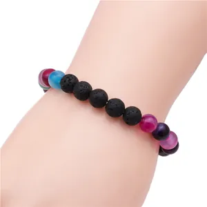 Close-up of beaded bracelet with black lava rock and colorful translucent stone beads