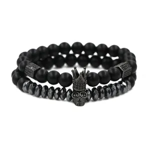 Matte black beaded bracelet set with skull and crown charms in gothic style
