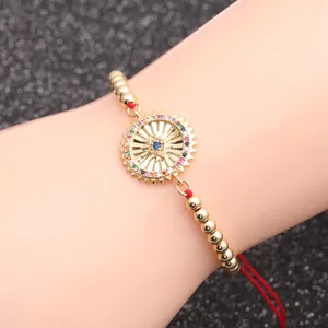 Türkisches Evil Eye Armband mit roter Schnur, goldenem Sonnenanhänger und Zirkonia