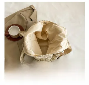 Internal view of straw beach bag showing beige lining and magnetic closure details