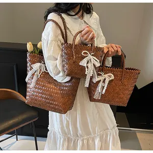Detailed set of brown woven tote bags with lace pearl bow charms in three sizes