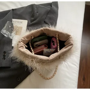 Detailed interior of beige feather crossbody bag showing storage space for phone and wallet