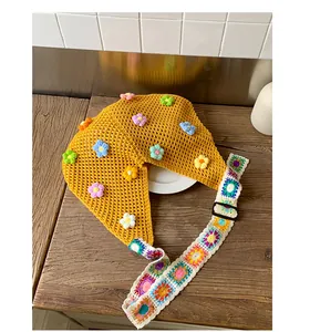 Dettaglio della borsa tote gialla all'uncinetto con fiori 3D colorati e tracolla geometrica