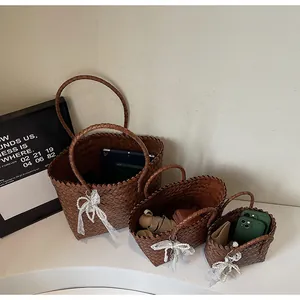 Three brown woven tote baskets in varied sizes showing storage capacity with lace bow charms