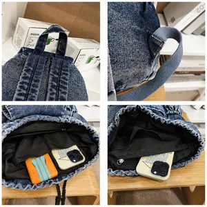 Detail view of denim backpack showing reinforced straps and interior storage compartments