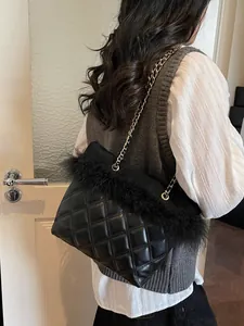 Elegant black quilted chain shoulder bag with plush feather trim and metallic strap