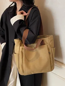 Large khaki canvas tote bag with brown straps shown on a model for daily casual commute