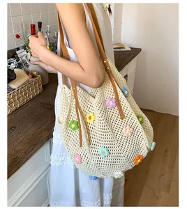 Detailed texture of hollow knit tote bag with colorful 3D crochet flowers and brown leather straps