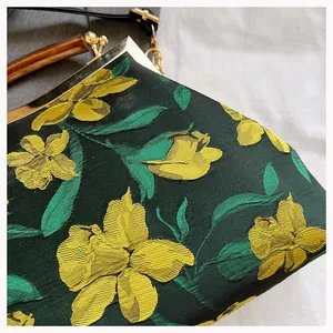 Detail of dark green floral jacquard fabric and tortoise shell handle on cheongsam bag