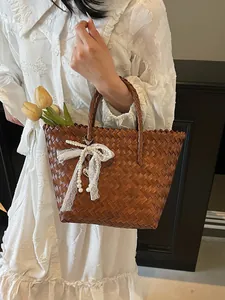 Vintage straw beach tote with lace bow, pearls, and heart charm for summer vacation