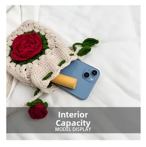 Capacidad interna del bolso de ganchillo con rosa mostrando un móvil y un labial