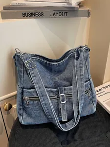 Vintage washed denim shoulder bag with multiple pockets and adjustable strap